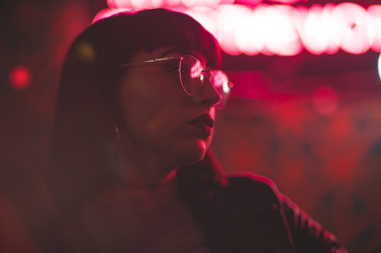 Girl with glasses in neon red lights