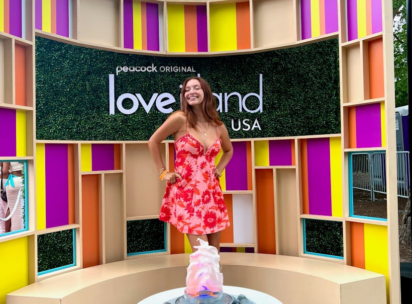 Girl in front of 'Love Island USA' sign, auditioning for the show.